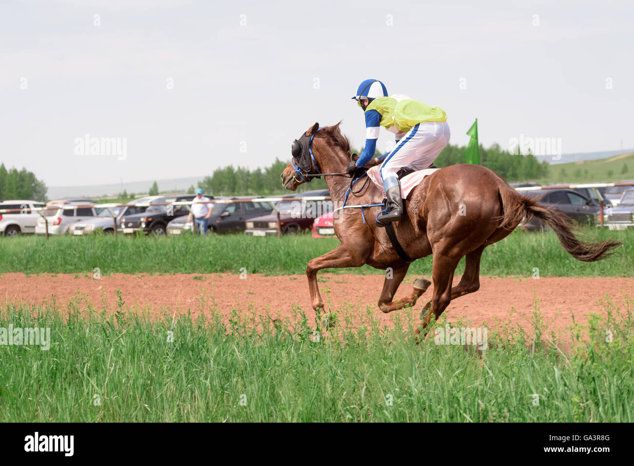 Galloping horses and their riders at a horse racing event in Summer ...