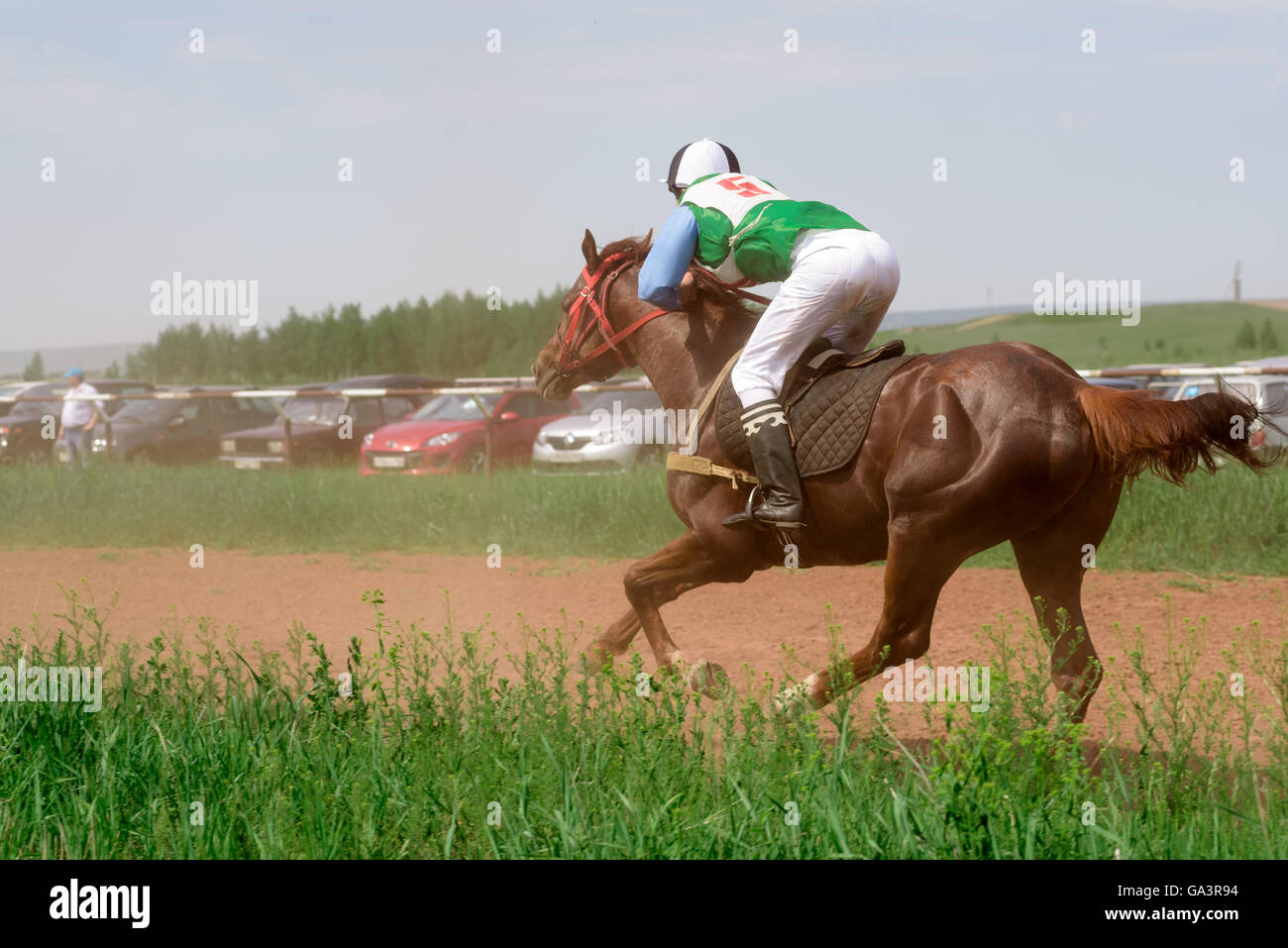 Galloping Horses And Their Riders At A Horse Racing Event In Summer