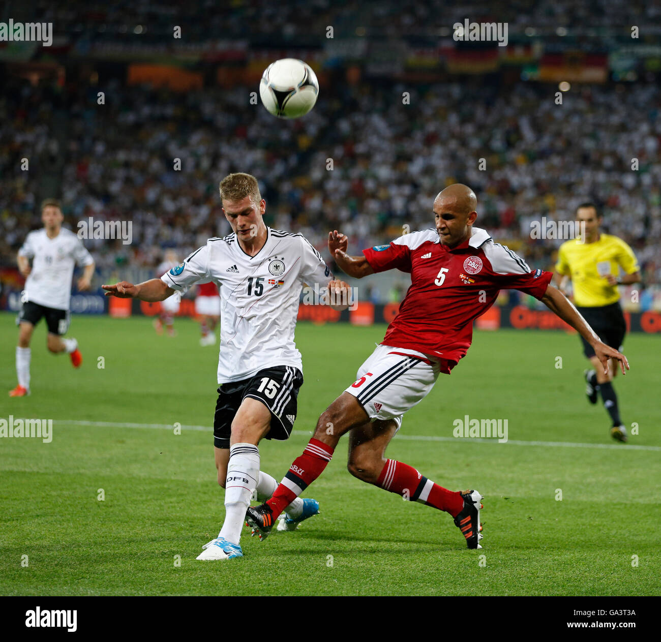 Lars Bender of Germany (L) fights for a ball with Simon Poulsen of Denmark during their UEFA EURO 2012 game at Lviv Arena Stock Photo