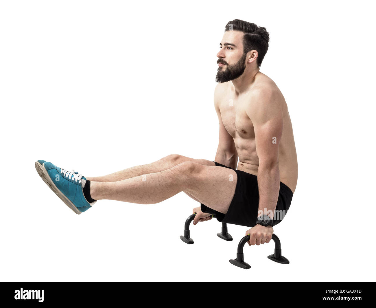 Shirtless fitness model balancing with raised legs on push up bars