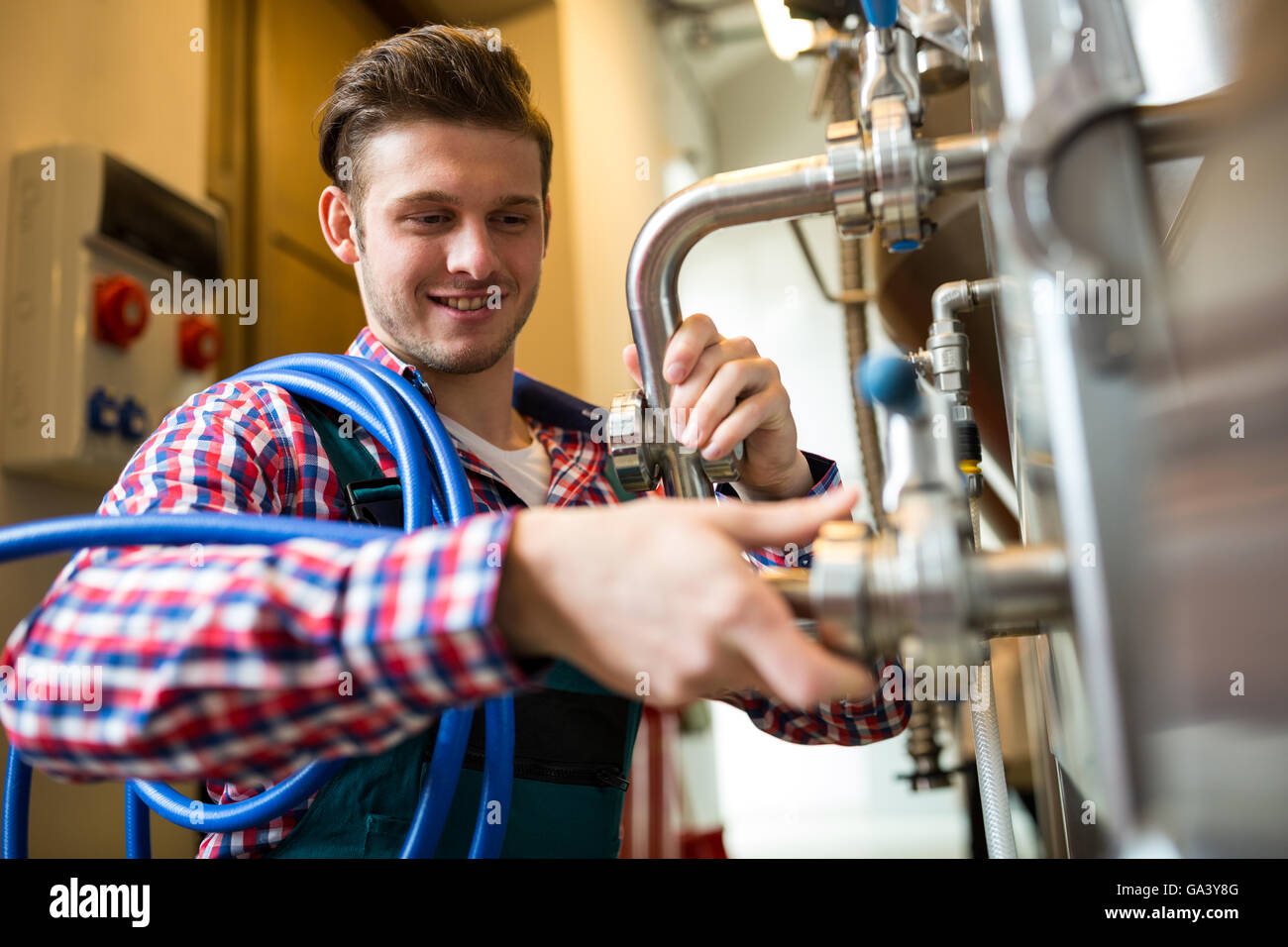 Maintenance workers examining brewery machine Stock Photo Alamy