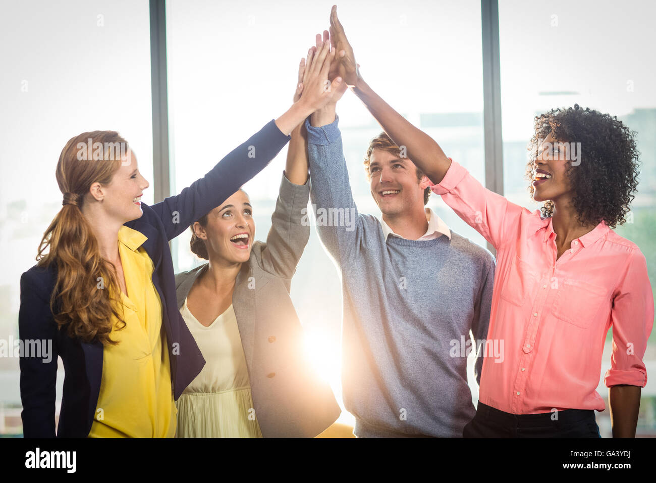 Business people giving high five to each other Stock Photo - Alamy