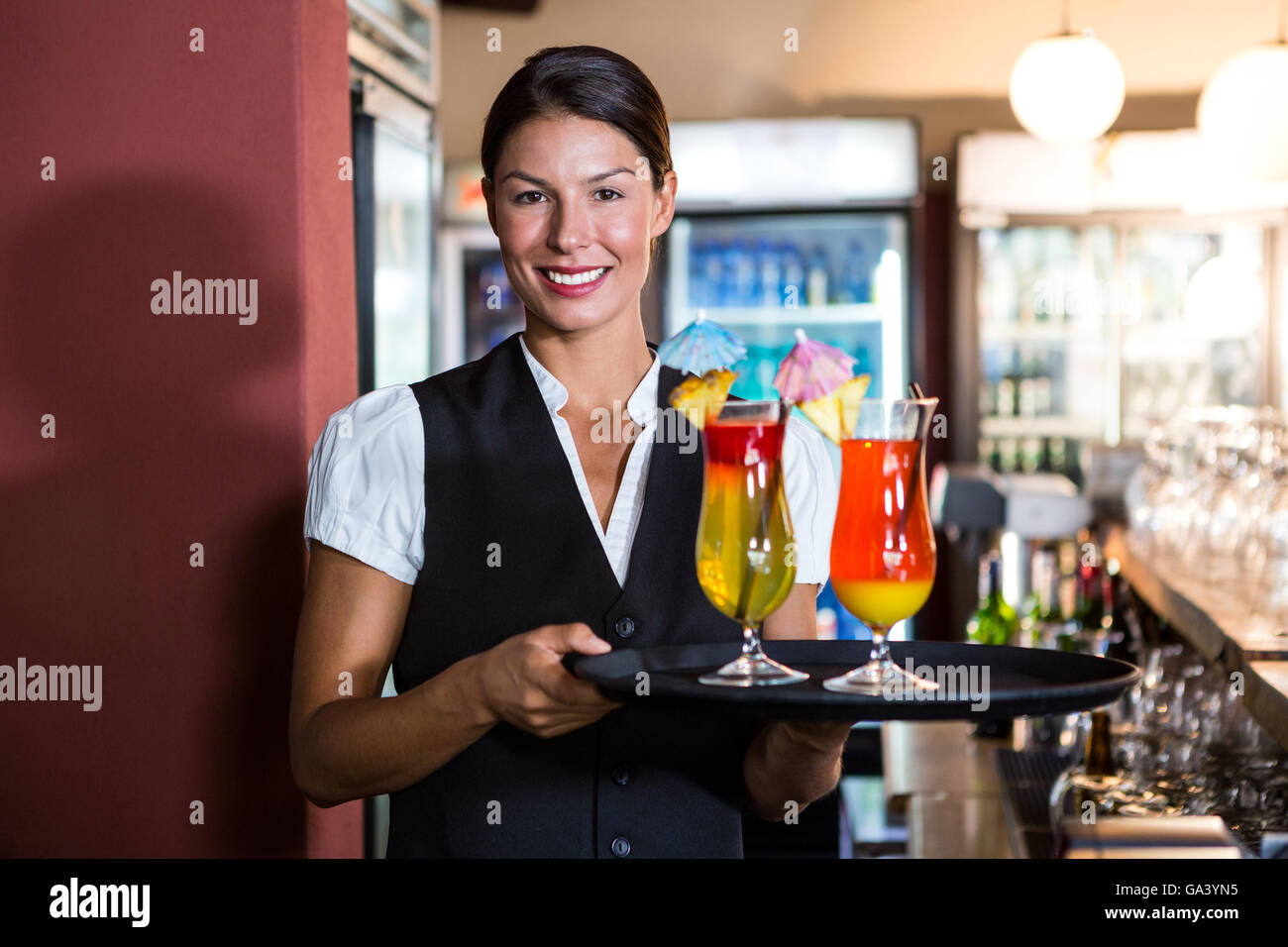 Waitress holding cocktails Stock Photo Alamy