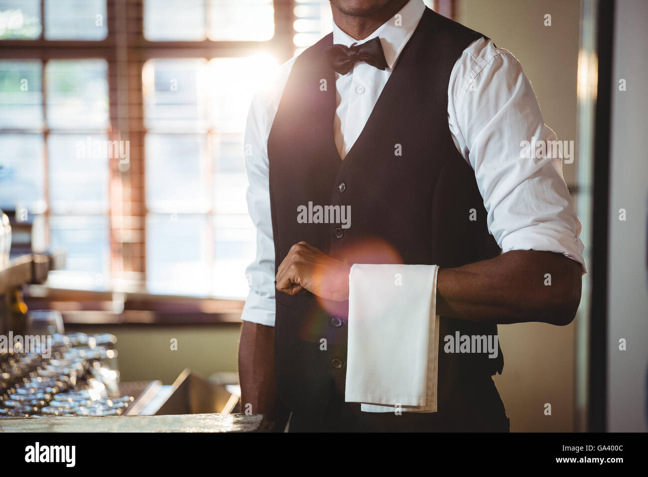Bartender with napkin draped on his hand Stock Photo Alamy