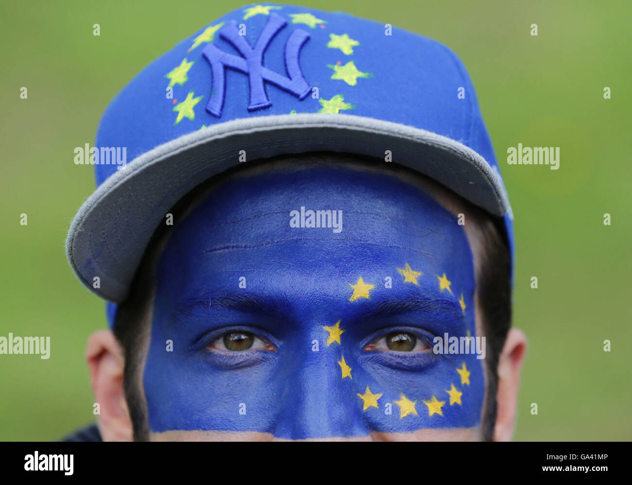 A man with the flag of the European Union painted on his face as Remain supporters gather on Park Lane in London, before marching to Parliament Square to show their support for the EU in the wake of Brexit. Stock Photo