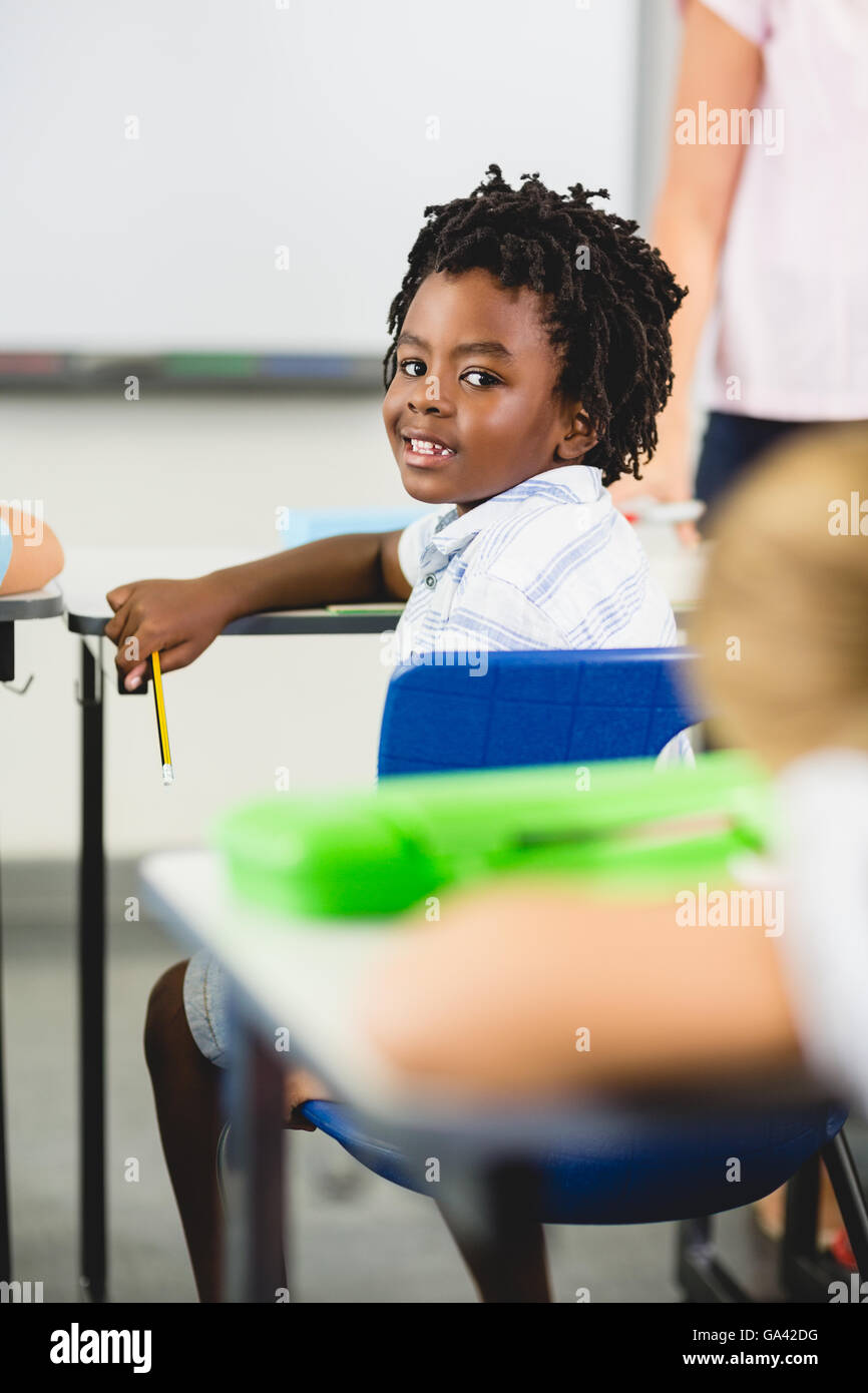 Schoolboy smiling in classroom Stock Photo - Alamy