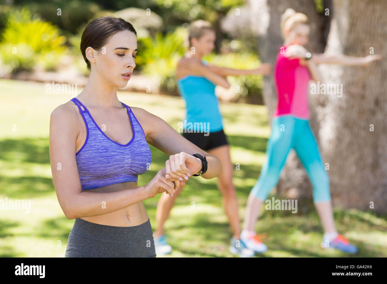Woman checking time while exercising Stock Photo