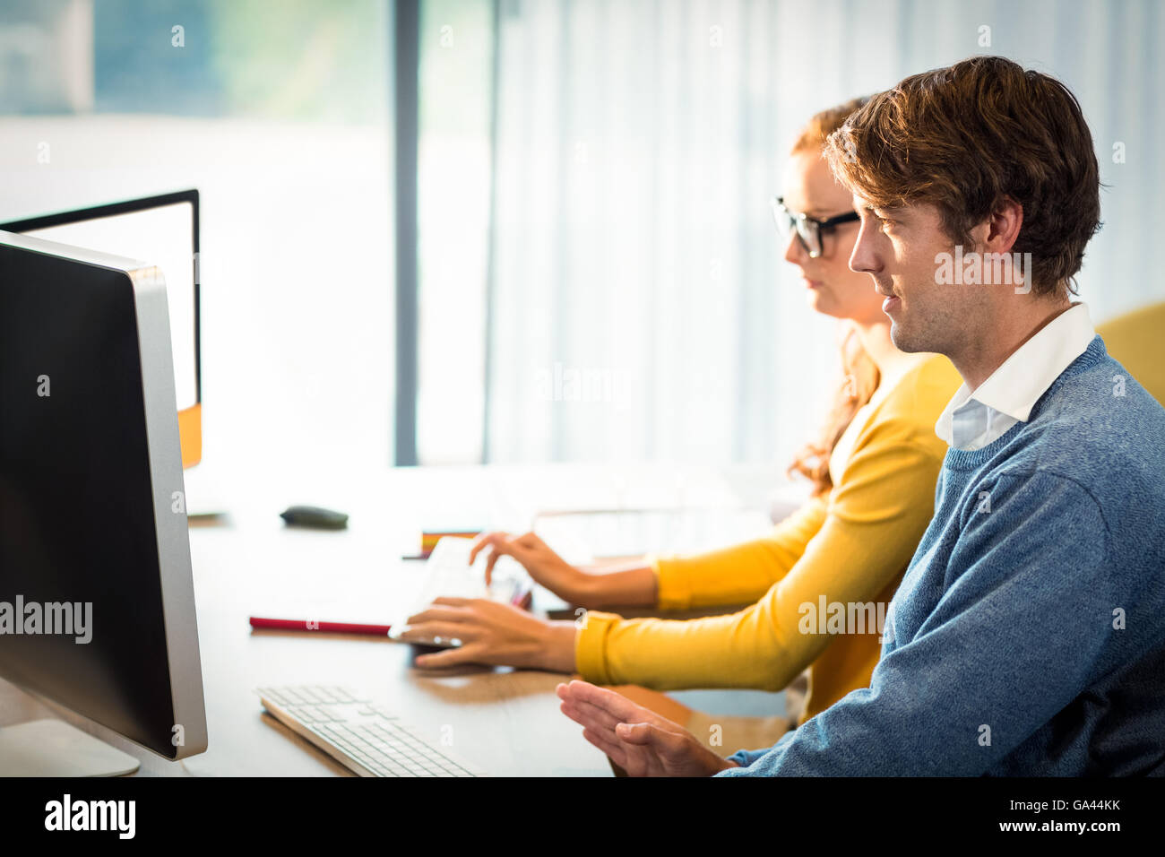 Executives working on computer Stock Photo - Alamy