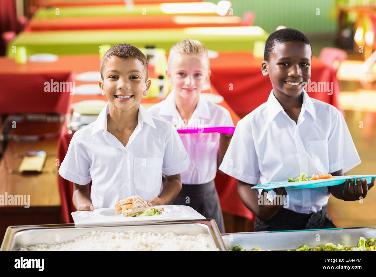 Student holding food tray in school cafeteria Stock Photo