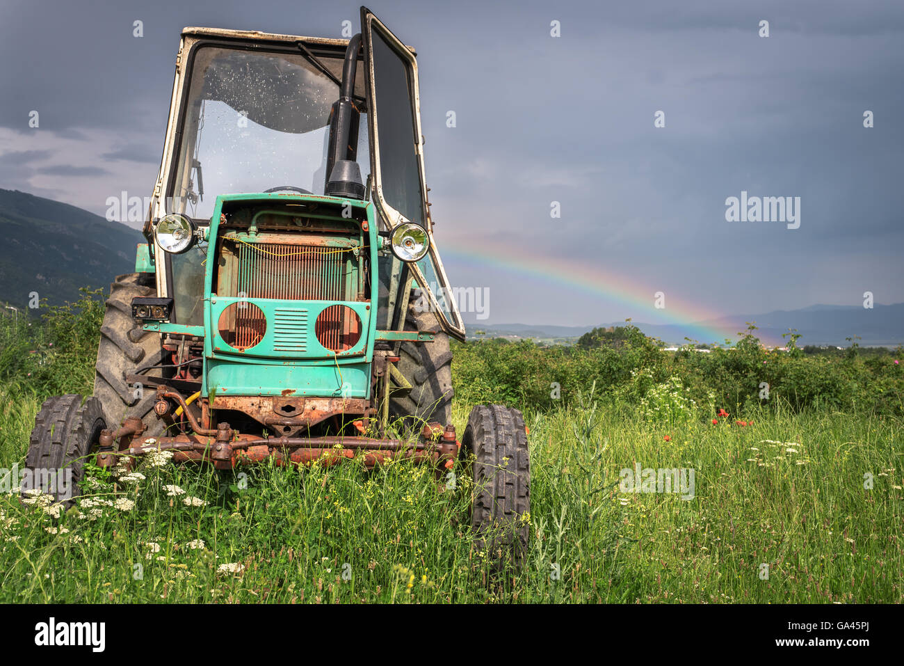 old tractor on the grass field Stock Photo