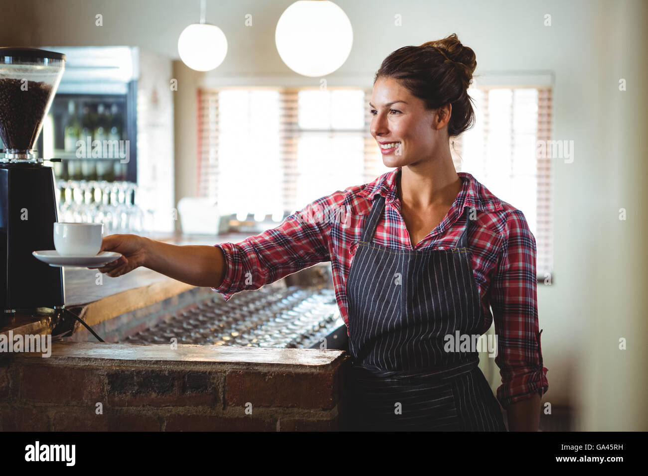 Waitress holding a cup of coffee Stock Photo