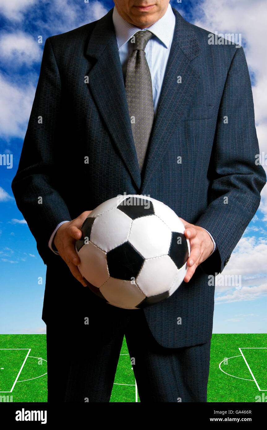 businessman holding a soccer ball, football as business concept Stock ...