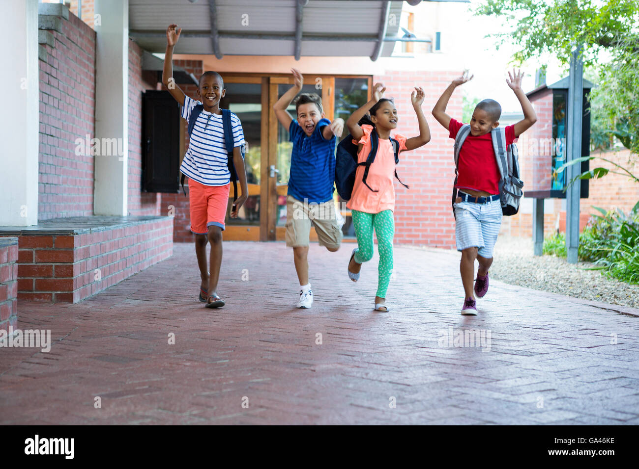 Classmates running at school corridor Stock Photo - Alamy