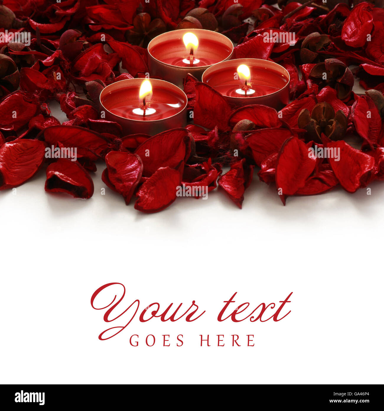 Red rose petals and candles on a white background Stock Photo - Alamy
