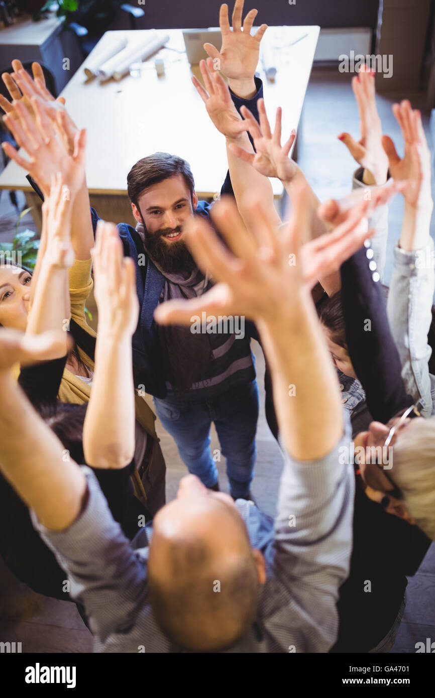 Creative business people cheering in office Stock Photo