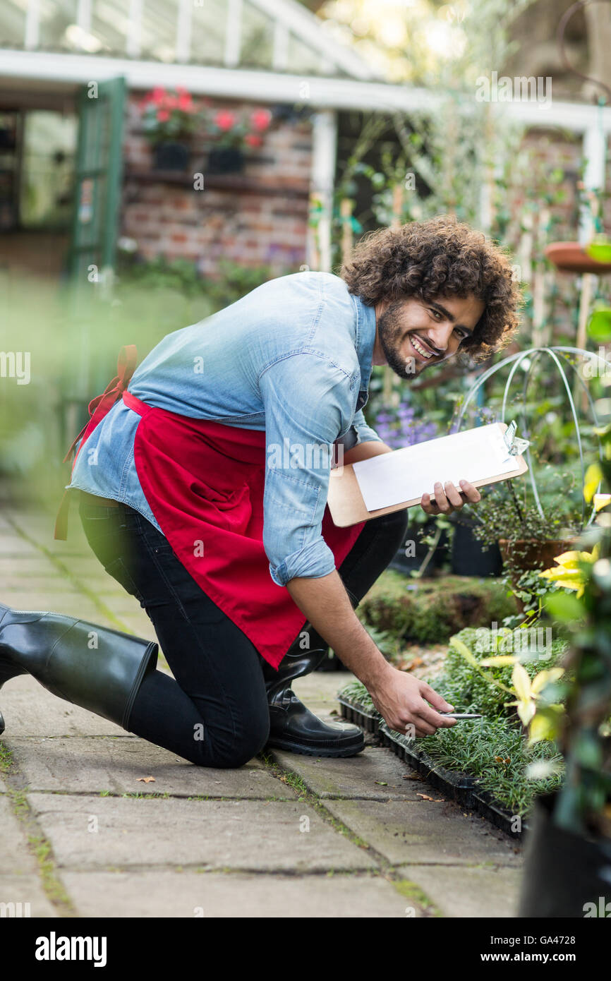 Happy male gardener working outside greenhouse Stock Photo
