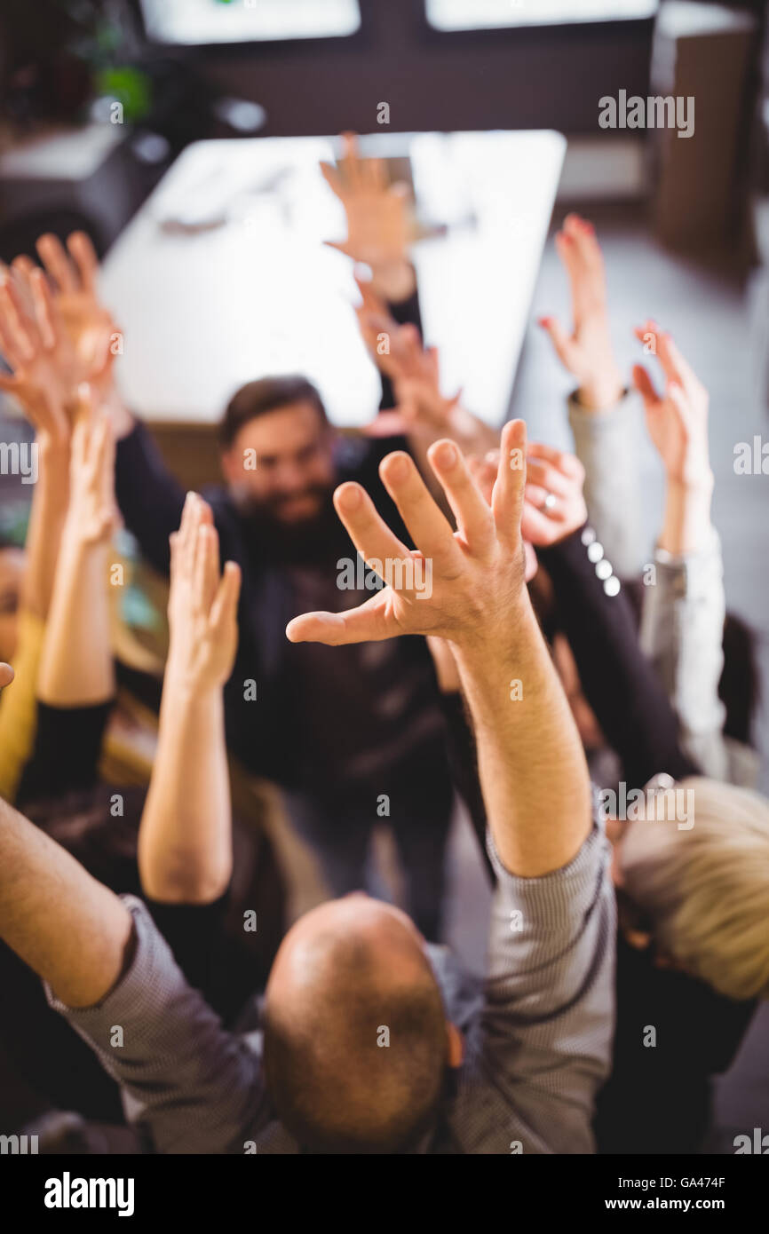 Business people cheering in creative office Stock Photo
