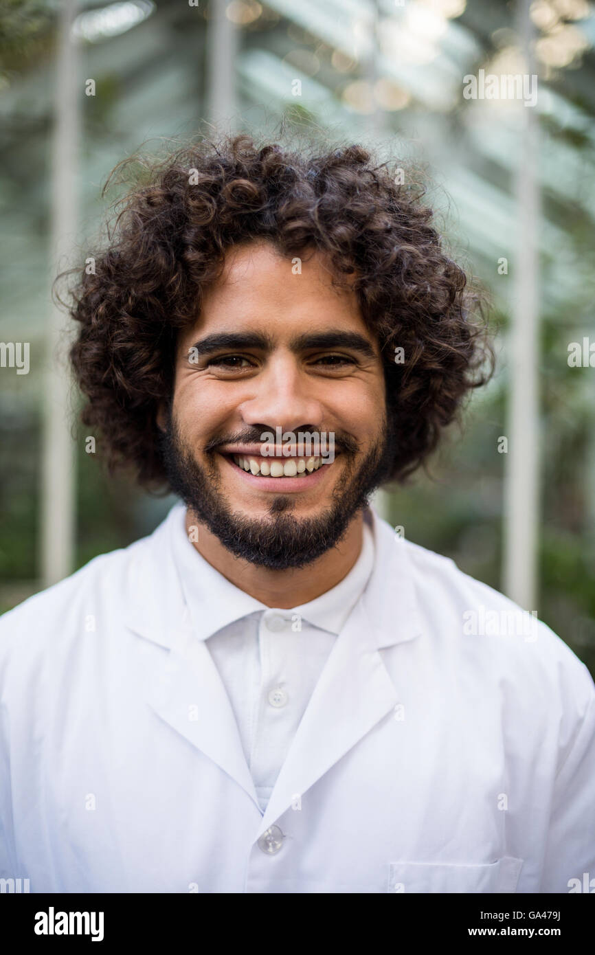 Confident male scientist against greenhouse Stock Photo