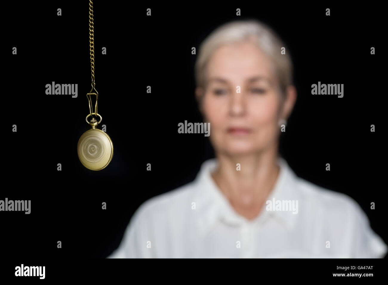 Woman being hypnotized with pendulum Stock Photo - Alamy