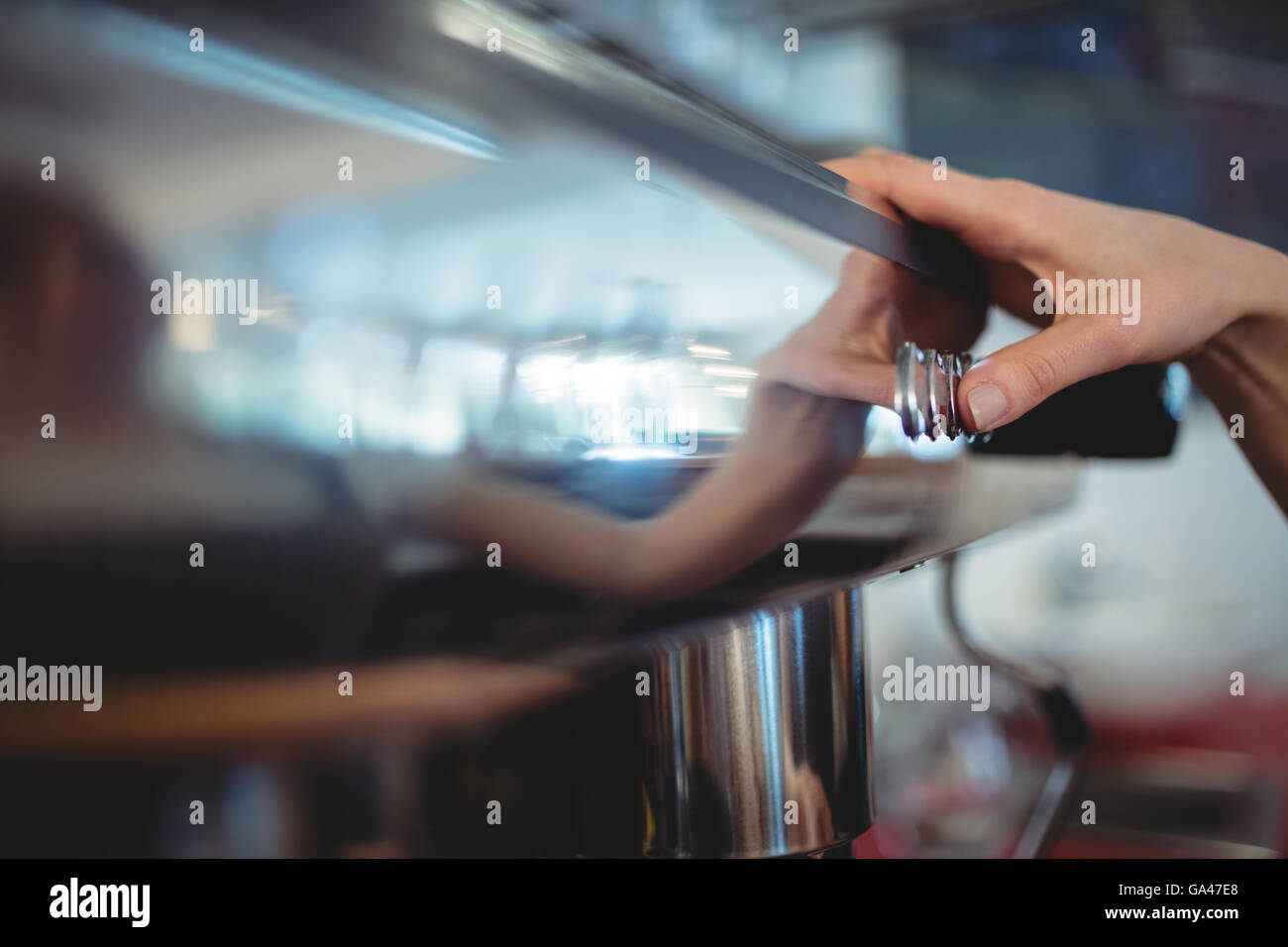 Close-up of barista pushing button on coffee maker at cafeteria Stock ...