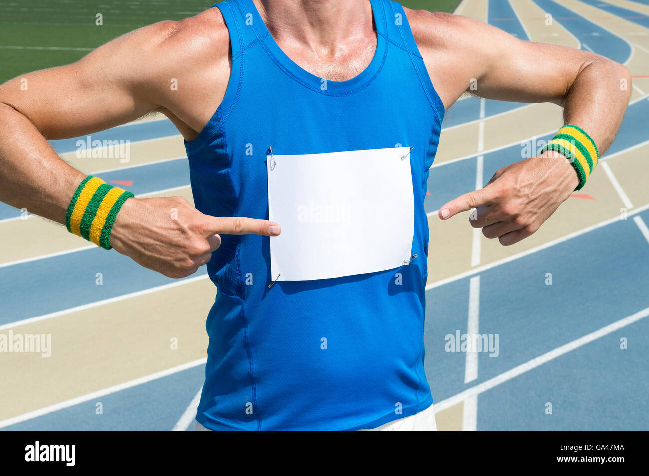 Brazilian athlete in Brazil colored wristbands pointing at blank race