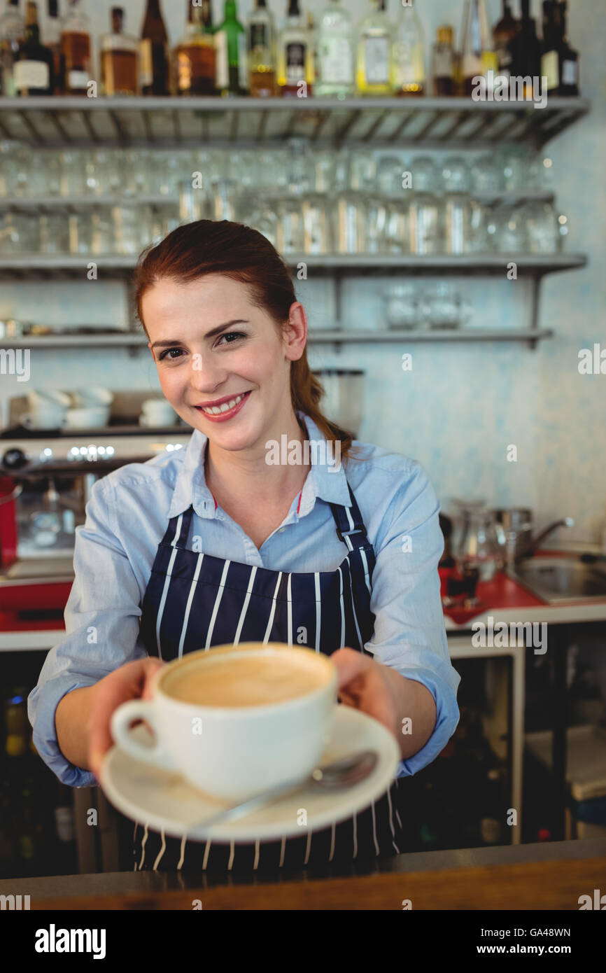 Portrait of confident barista serving coffee at cafeteria Stock Photo