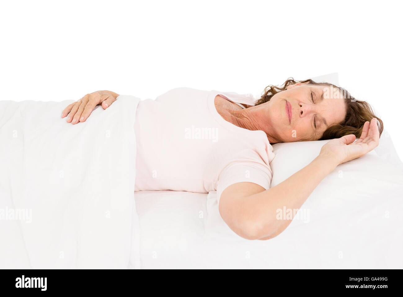 Mature woman relaxing on bed Stock Photo