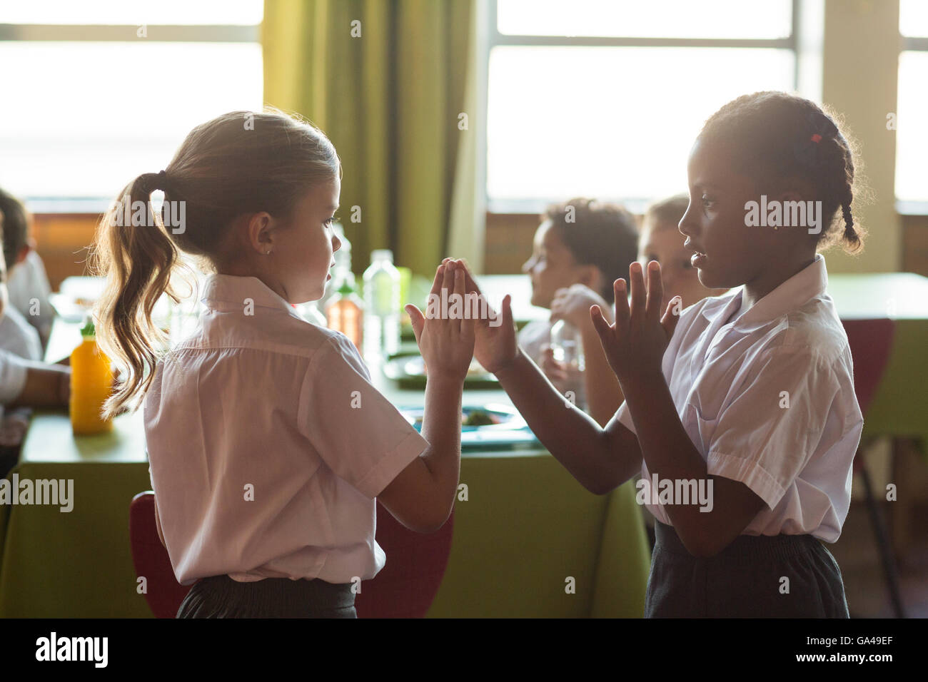 Girls playing clapping game Stock Photo