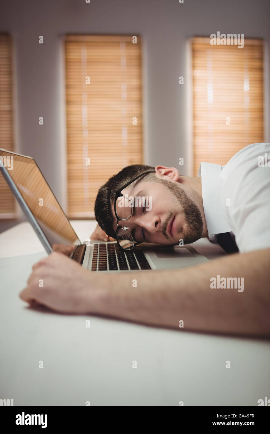 Young man sleeping in office Stock Photo