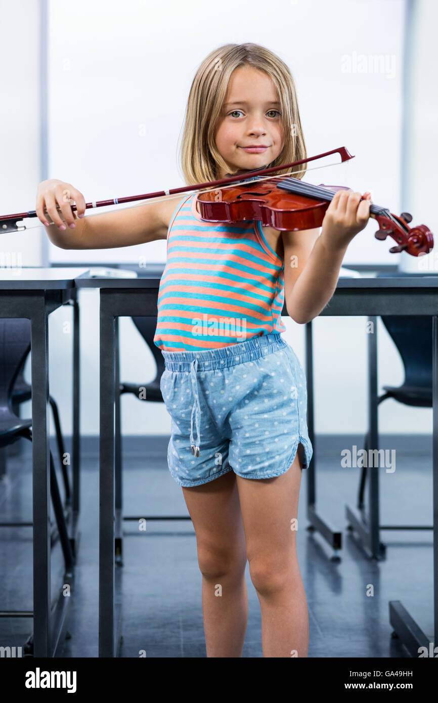 Portrait of girl playing violin in classroom Stock Photo - Alamy