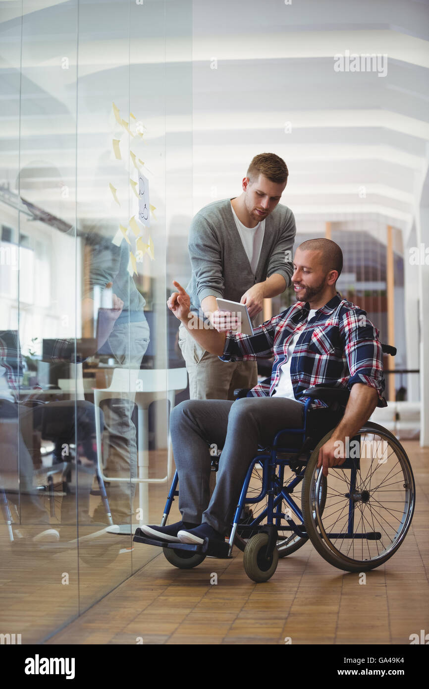 Handicap businessman discussing with colleague at office Stock Photo