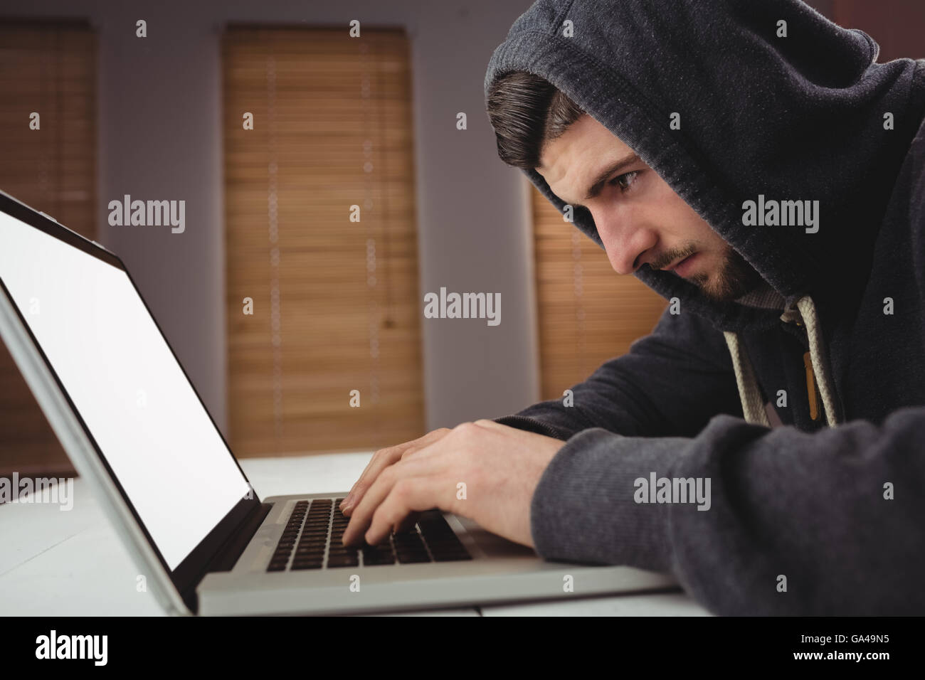 Young man using laptop in office Stock Photo