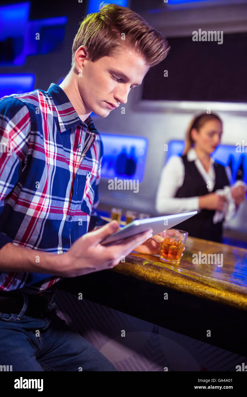 Man using digital tablet with bartender working Stock Photo