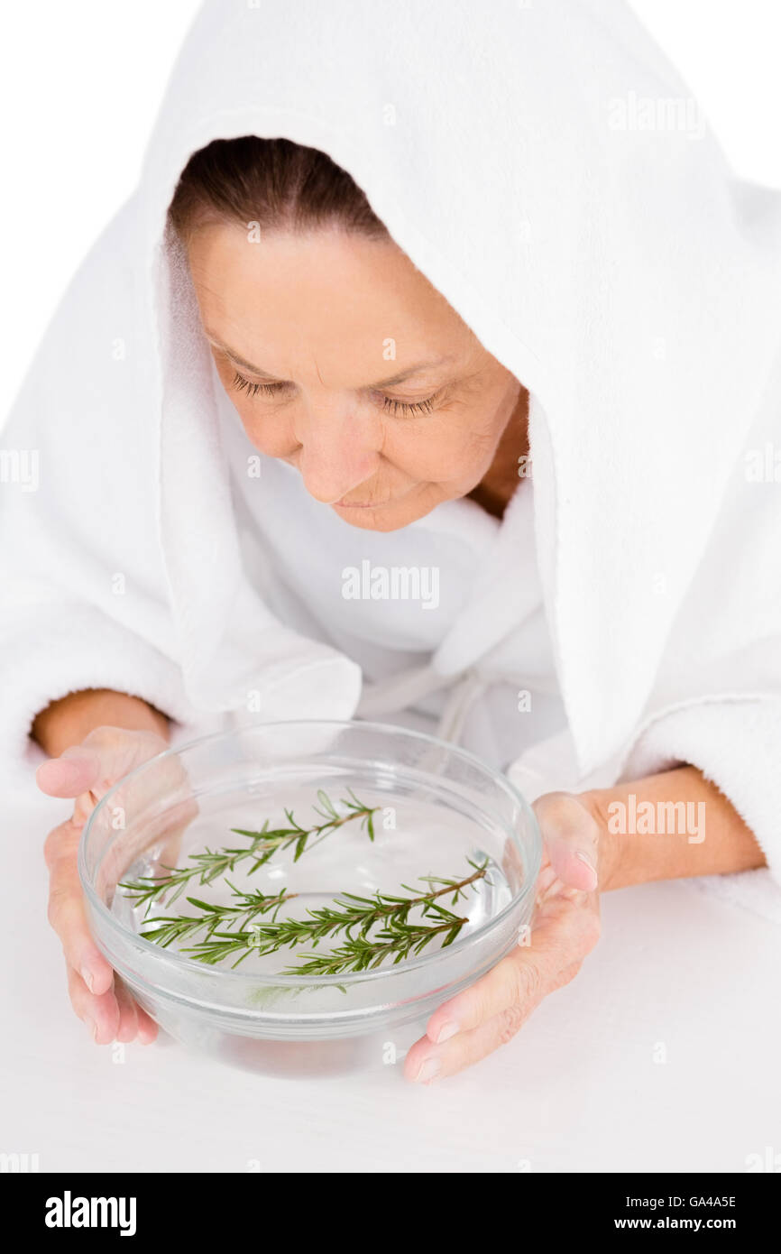 Woman steaming face with rosemary in bowl of water Stock Photo Alamy