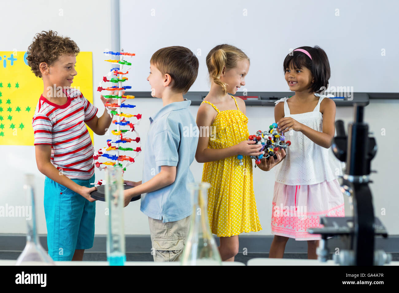 Happy schoolchildren in laboratory Stock Photo