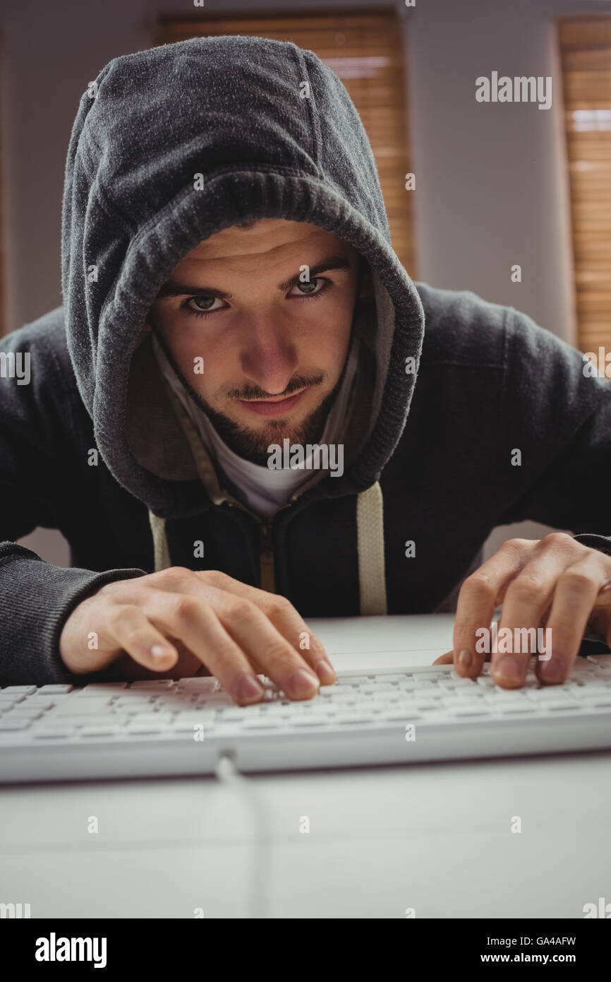 Portrait of young man using computer keyboard Stock Photo