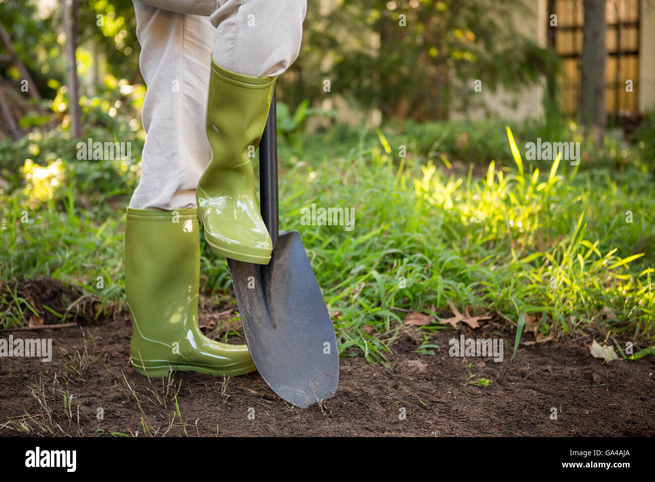 Low section of female gardener with shovel at garden Stock Photo