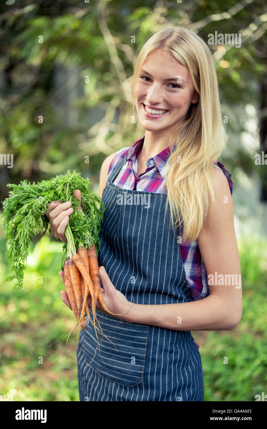 Portrait of happy gardener with carrots at garden Stock Photo - Alamy