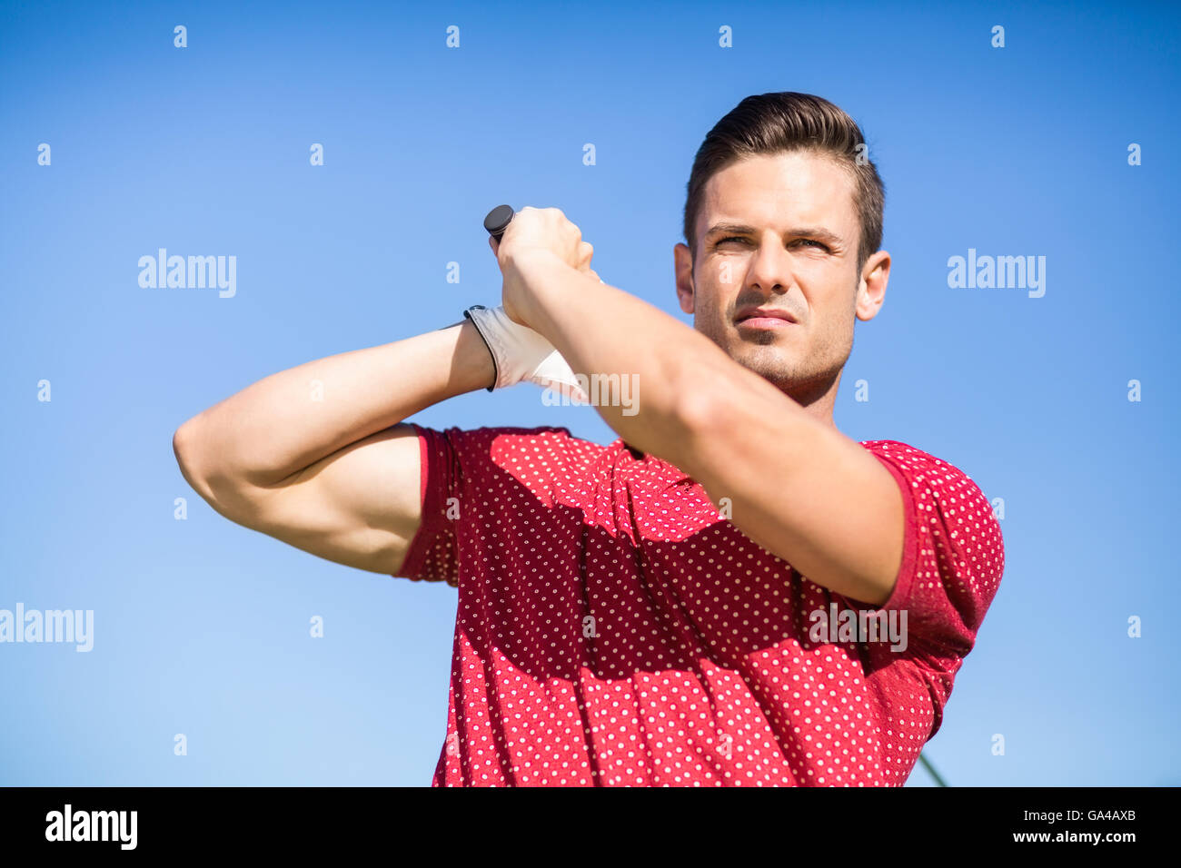 Low angle view of golfer man taking shot Stock Photo