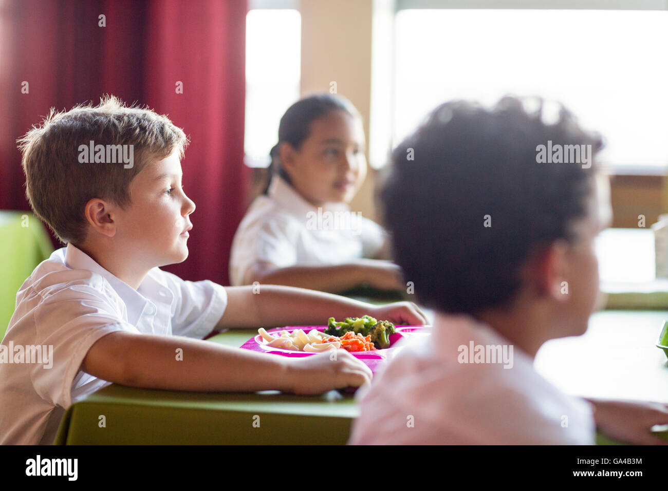 Boy with classmates in canteen Stock Photo Alamy