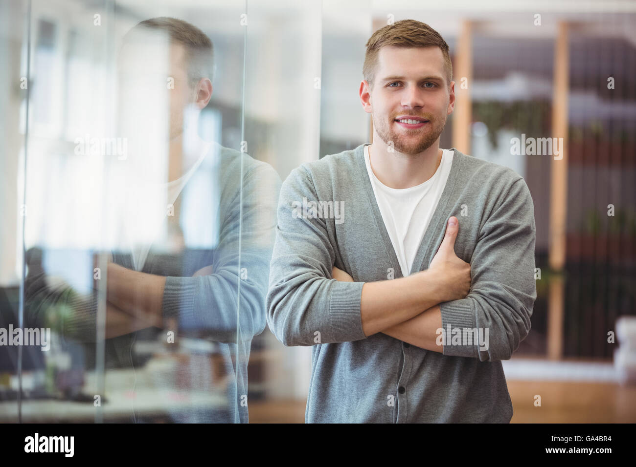 Portrait of happy businessman with arms crossed in office Stock Photo ...