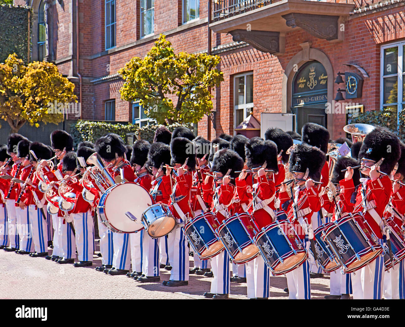 Copenhagen, Denmark - the Tivoli Youth Gard boys perform in red-white  uniform and bearskin hat at Tivoli Gardens Stock Photo - Alamy