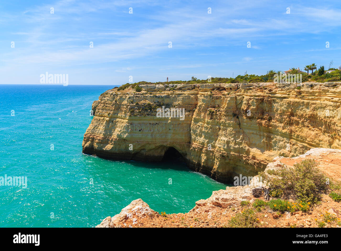 Turquoise sea and cliff rocks on coast of Portugal near Carvoeiro town, Algarve region Stock Photo