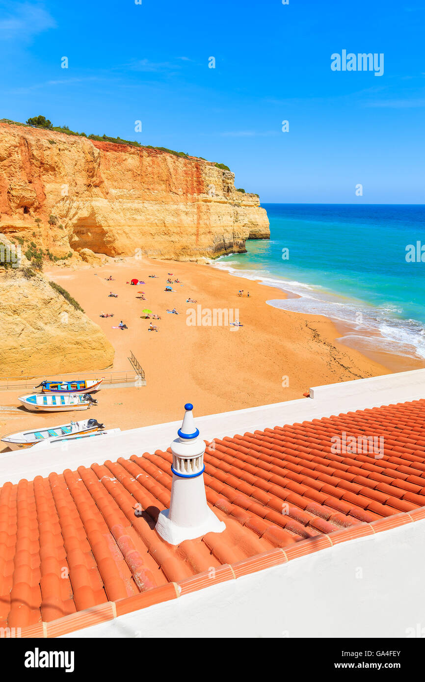 Orange tiles on roof of a house on sandy Benagil beach in Algarve region of Portugal Stock Photo