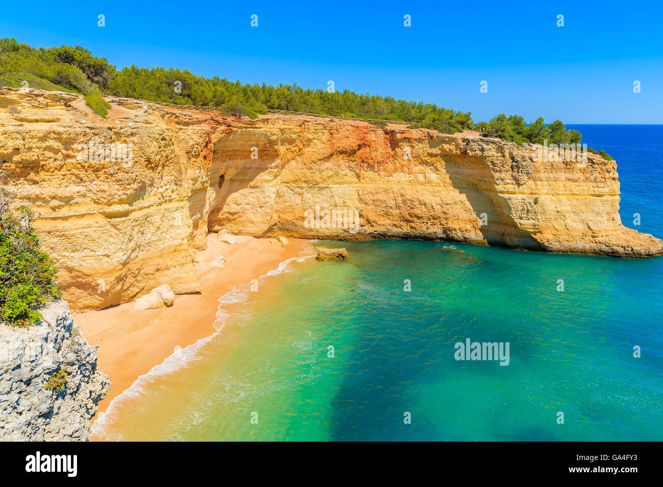 View of beautiful beach with crystal clear turquoise water near Carvoeiro town, Algarve region, Portugal Stock Photo