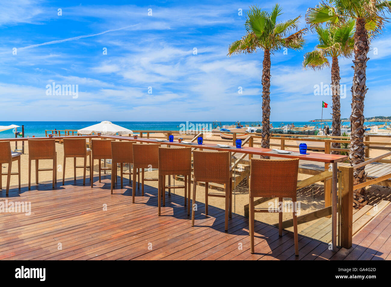 Chairs on terrace of a restaurant on Armacao de Pera beach in Algarve region, Portugal Stock Photo
