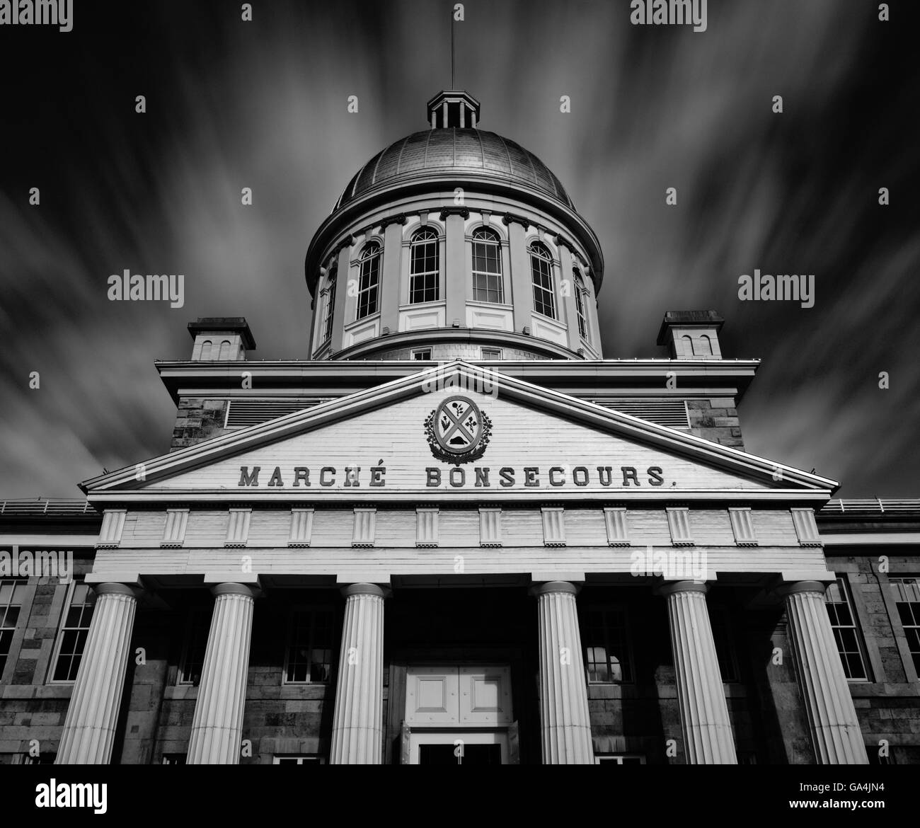 Long exposure with moving clouds over Marche Bonsecours, Montreal, Quebec Canada Stock Photo