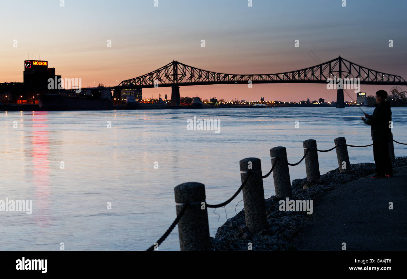 A man fishing from Parc de la Cite du Havre and Pont Jacques Cartier