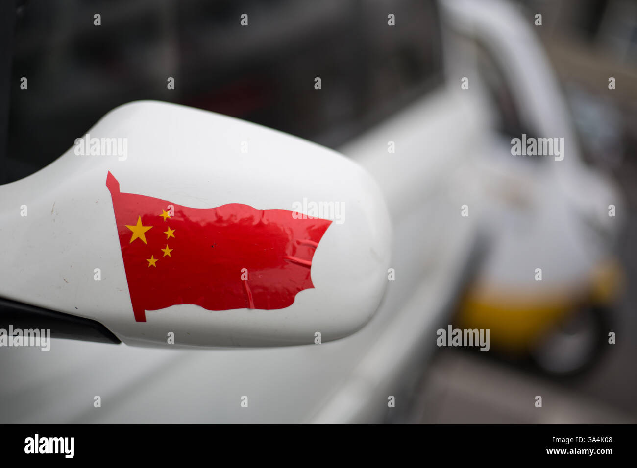 Chinese flag sticker on the wing mirror of a car, in Beijing, China. Stock Photo