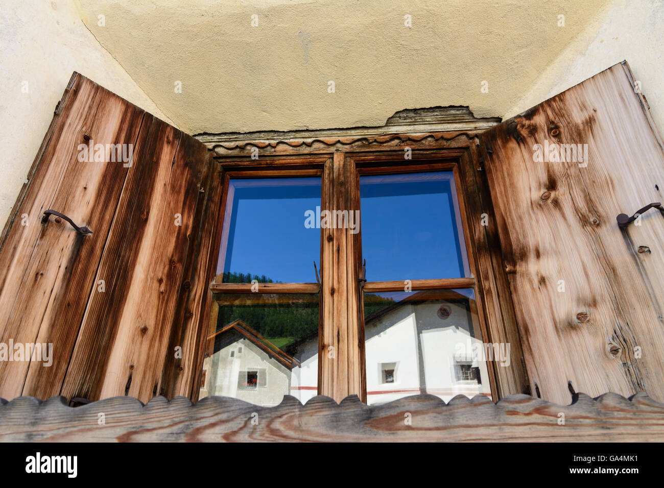 Guarda Reflection in an apartment building window Switzerland Graubünden, Grisons Unterengadin, Lower Engadine Stock Photo
